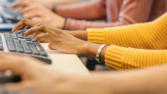 People typing at computers